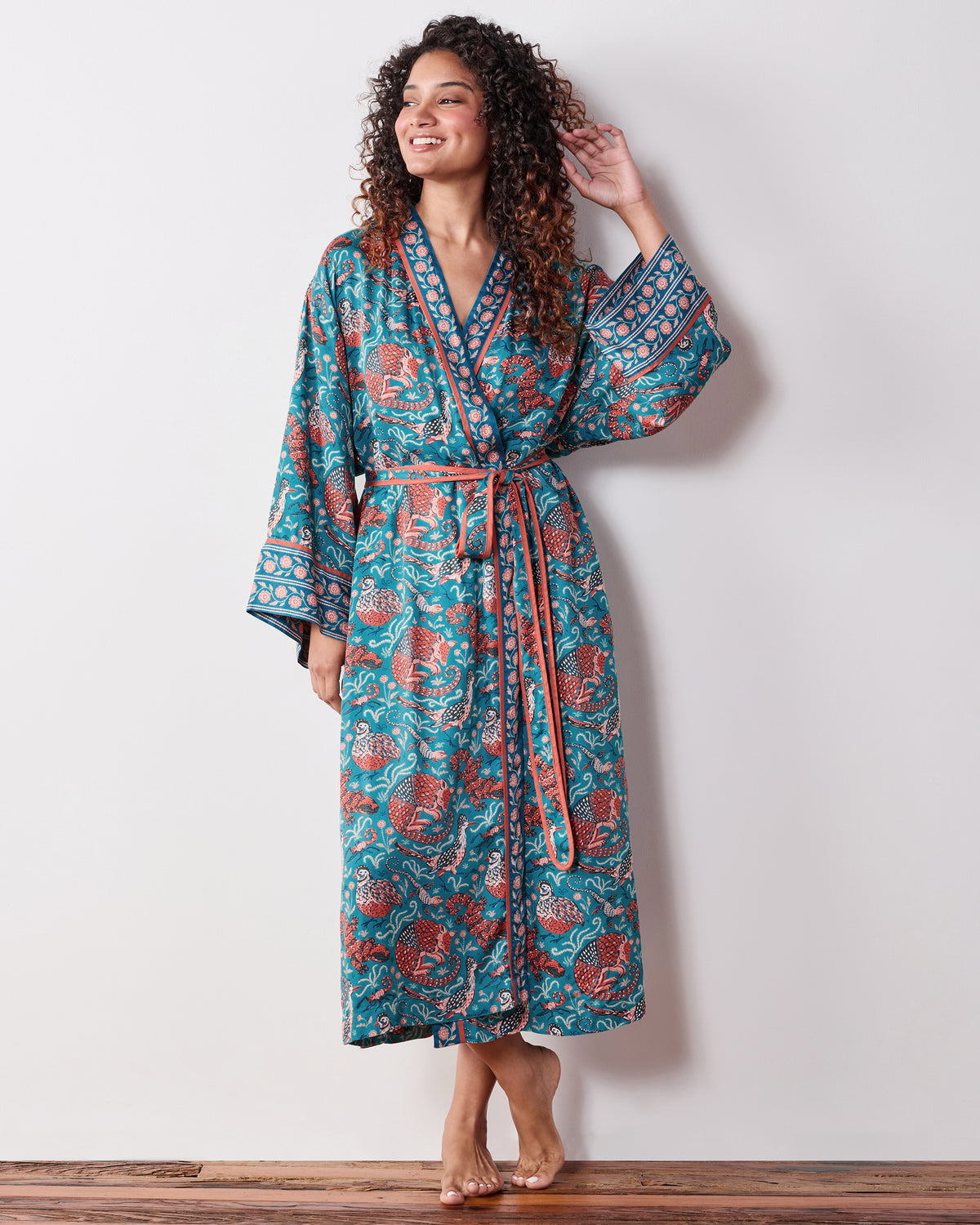 Full-length view of the teal Canyon Critters Eco Satin Robe with a belted wrap front, long sleeves, and animal-and-flora print.