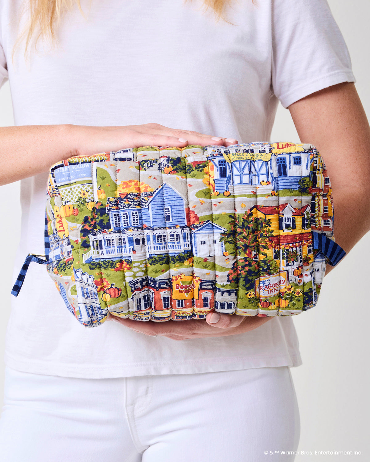 Illustrated Stars Hollow oversized pouch held horizontally in front of a person wearing a white shirt.