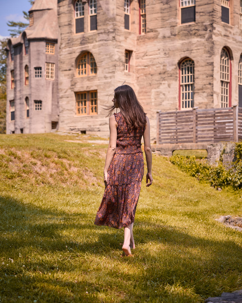 Back view of the sleeveless patterned Ellis midi dress outdoors.