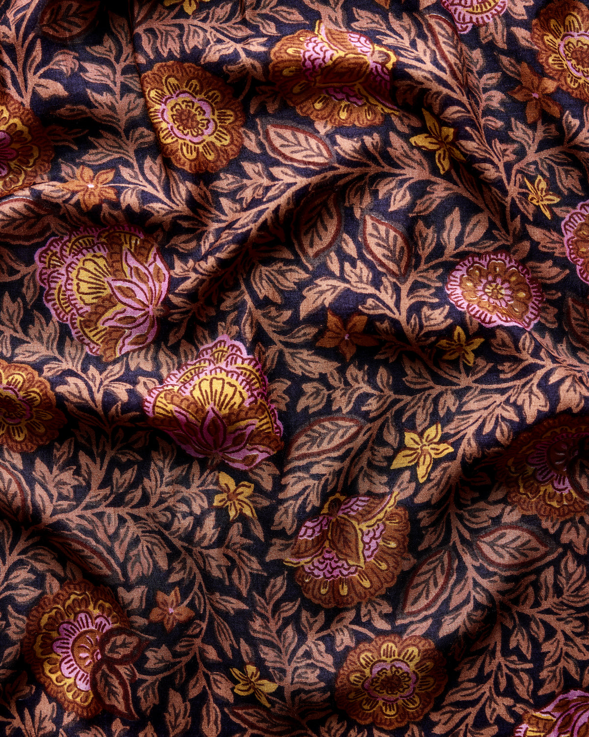 Prairie Dusk fabric swatch with a dark blue background and repeating multicolor floral vines.