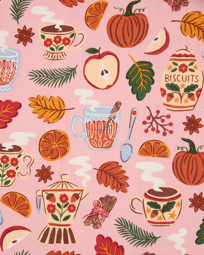 Autumn Cafe print swatch showing pumpkins, apples, citrus, leaves, teacups, teapots, and biscuit jars on a pink background.