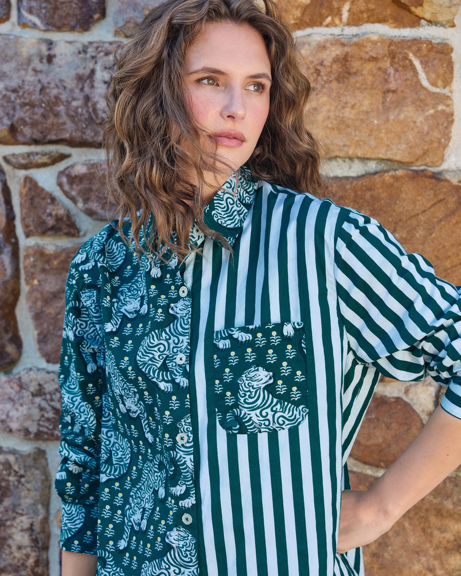 Close view of the Tiger Queen button-down shirt showing the split tiger-print and green-and-white striped design, collar, buttons, and chest pocket.