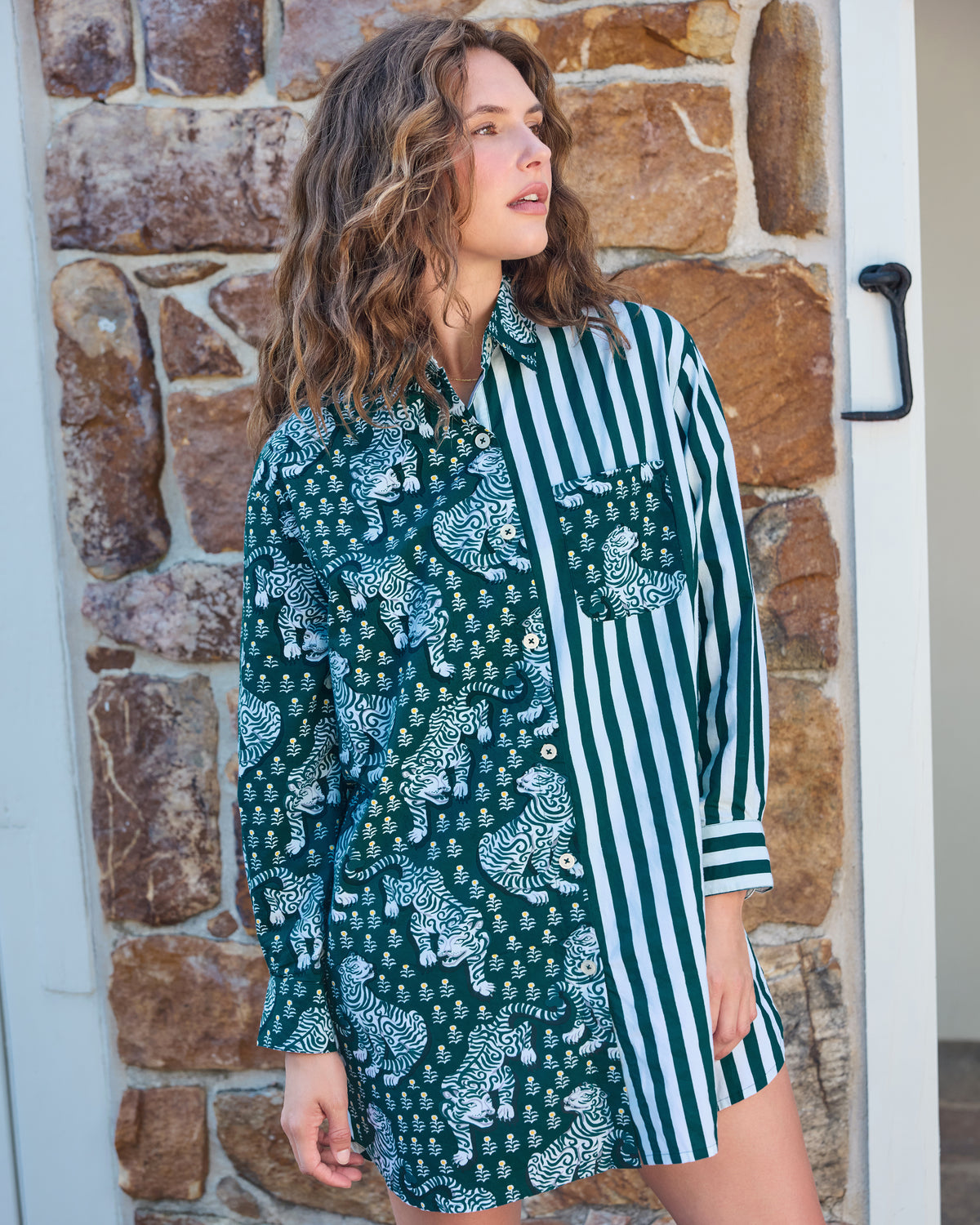 Front view of the Tiger Queen button-down shirt with a split tiger-print and green-and-white striped design, long sleeves, and chest pocket.