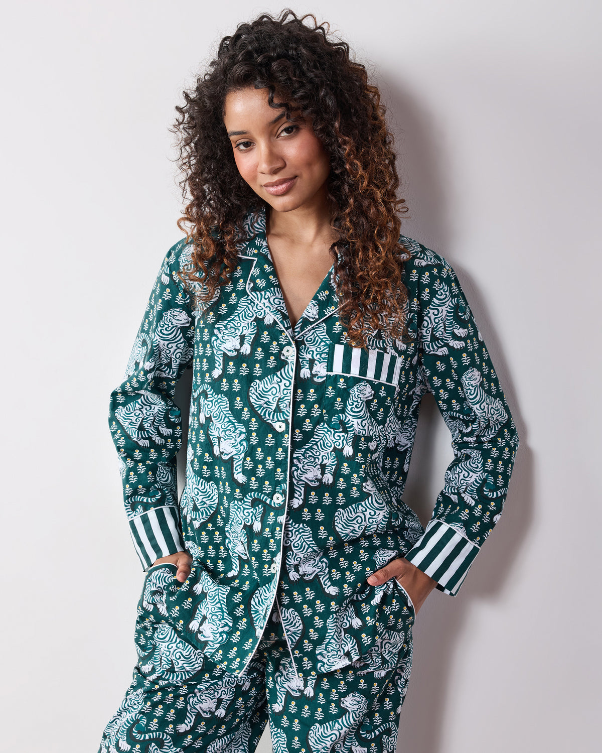 Front view of a person wearing the Game Day Green Tiger Queen long pajama set with a button-down top, chest pocket, drawstring pants, and striped cuffs.