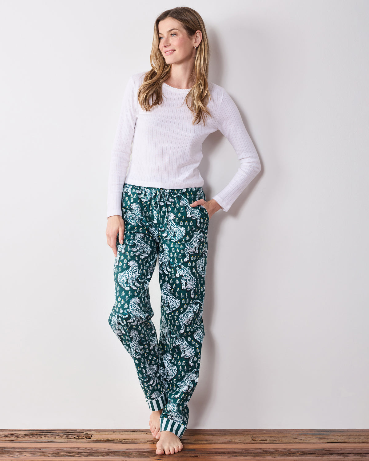 Front view of the full-length Tiger Queen pajama pants with an all-over tiger print, elastic waistband, and striped ankle cuffs.