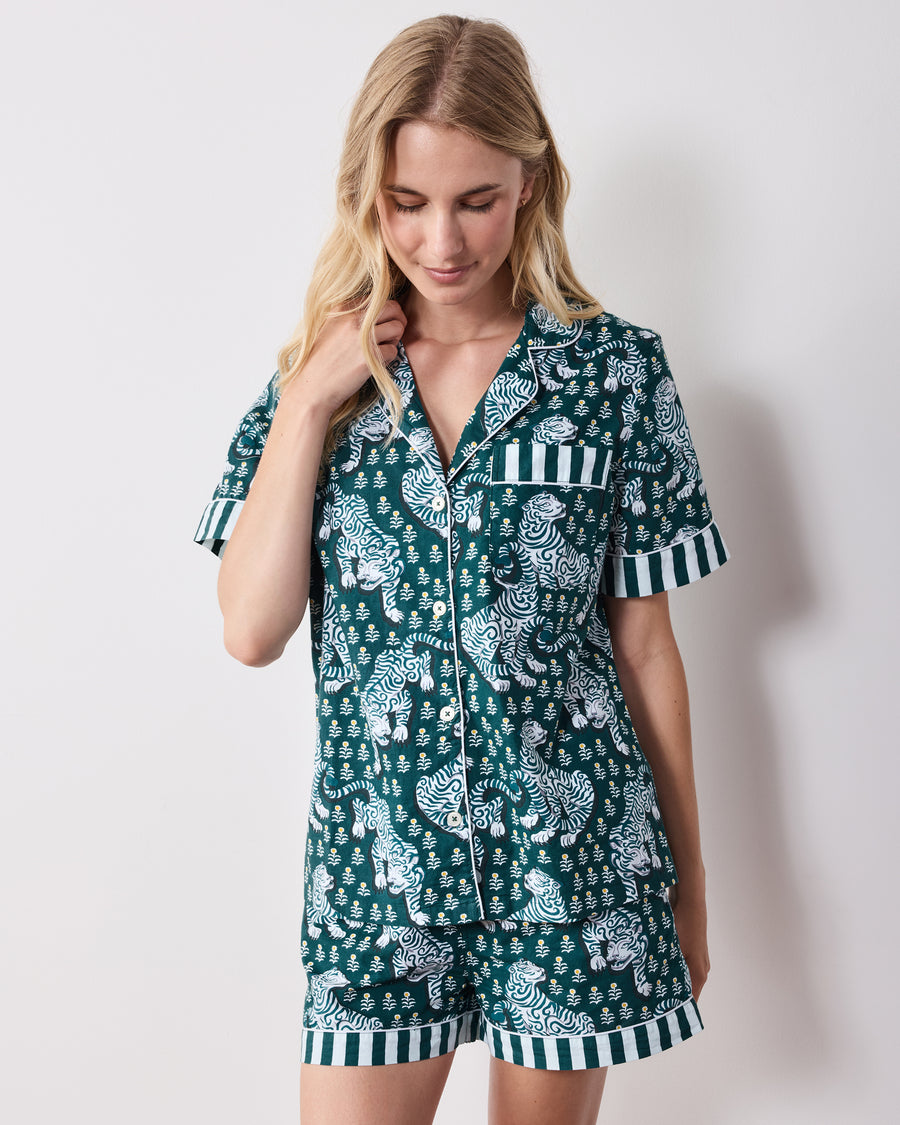 Front view of a green short-sleeve tiger-print pajama set with a button-front top, chest pocket, and matching shorts.