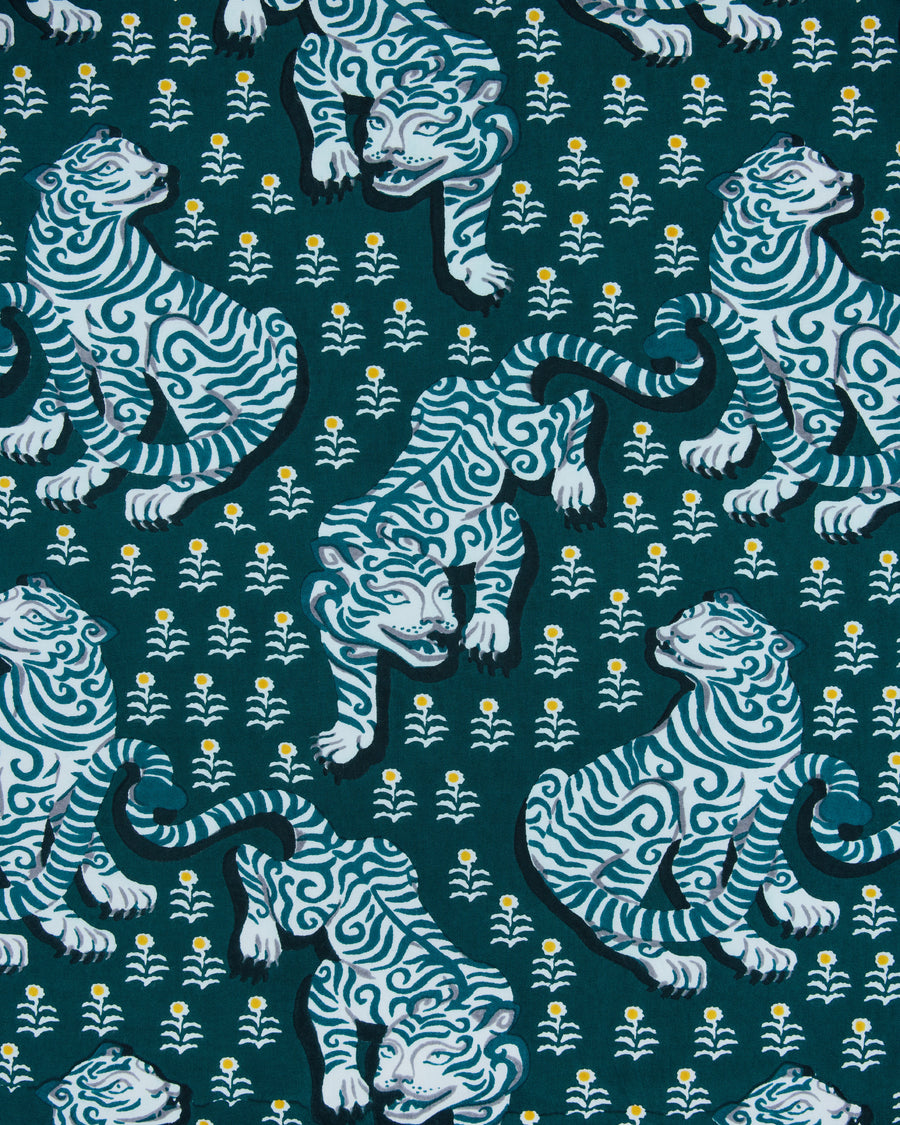Game Day Green pajama fabric with a repeating pattern of white-and-blue tigers and small white flowers with yellow centers
