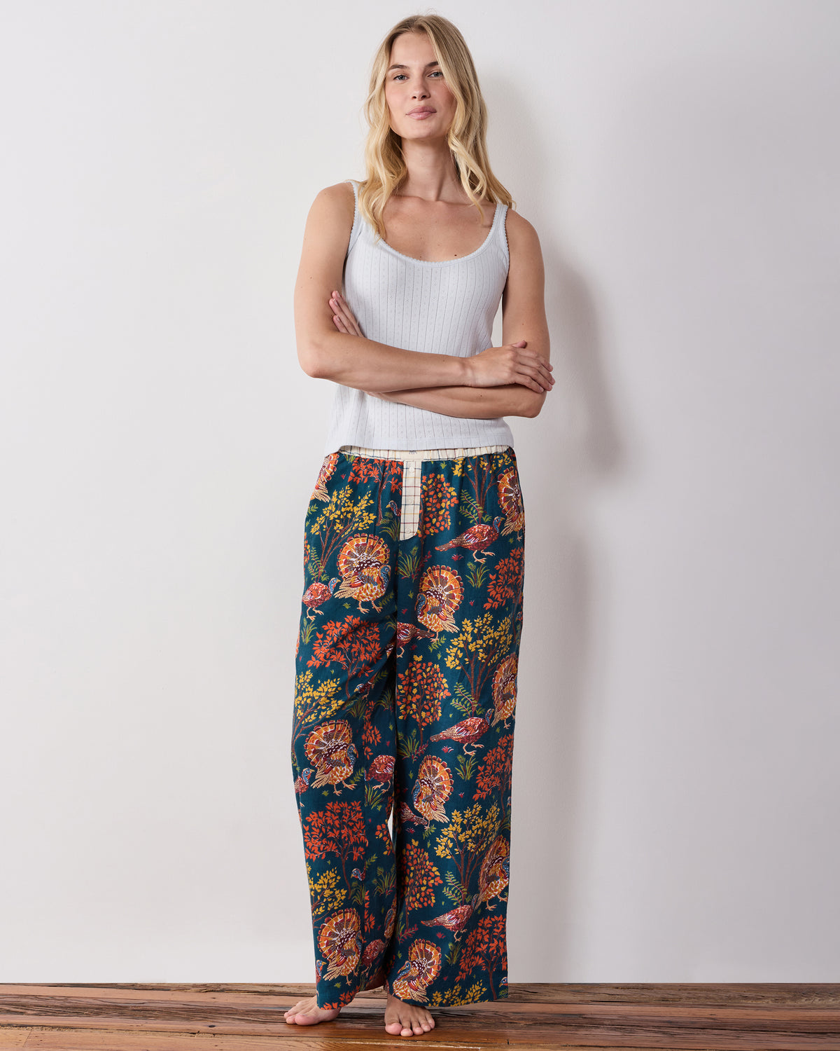 Full-length front view of the navy Turkey Trot wide-leg pajama pants with a contrasting waistband and turkey and foliage print.
