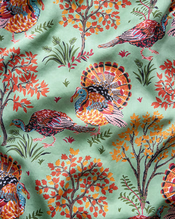 Pale green pattern with illustrated turkeys, autumn-colored trees, grasses, and small leaves.