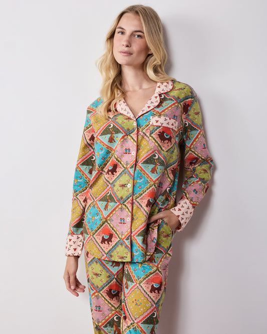 Front view of the Western Scenes long pajama set, with a button-front shirt, contrasting collar and cuffs, chest pocket, and matching printed pants.