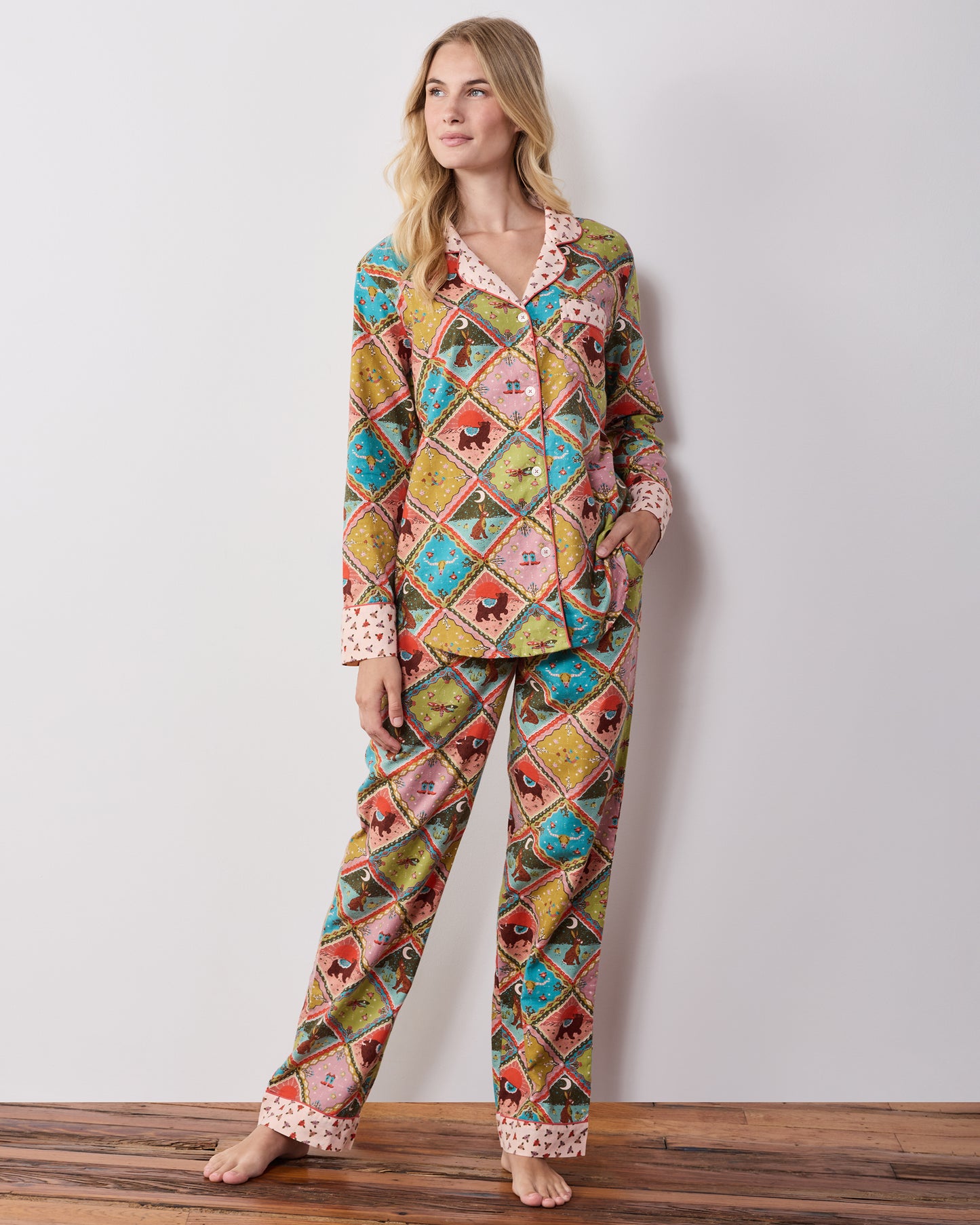Full-length view of the olive Western Scenes long pajama set with a multicolored diamond print and contrasting patterned collar, cuffs, and pocket trim.