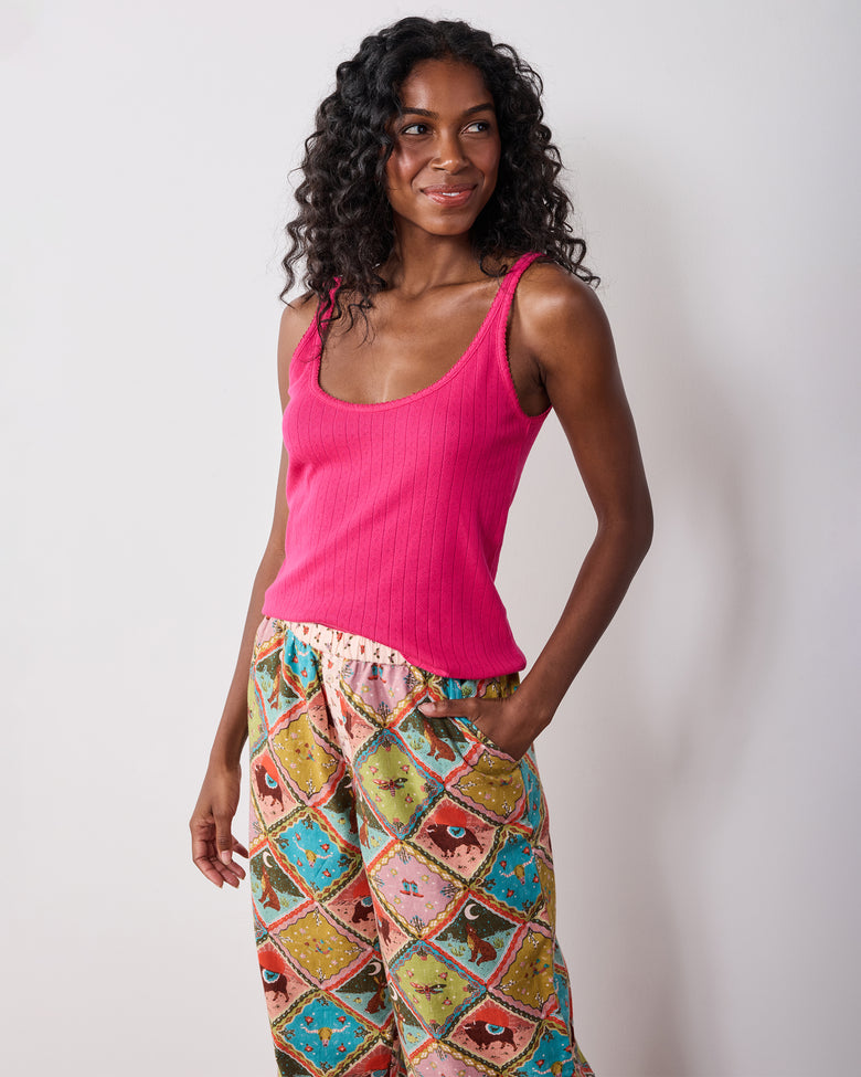 Model wearing the Western Scenes wide-leg pajama pants with a bright pink sleeveless top, shown from the front.