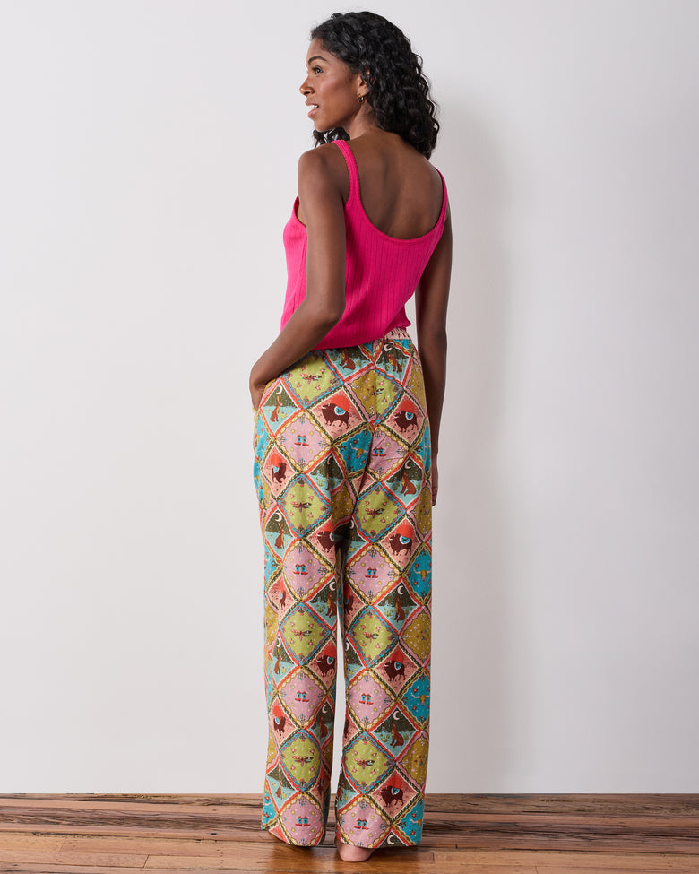 Back view of the Western Scenes wide-leg pajama pants worn with a pink tank top, showing the full-length relaxed silhouette.