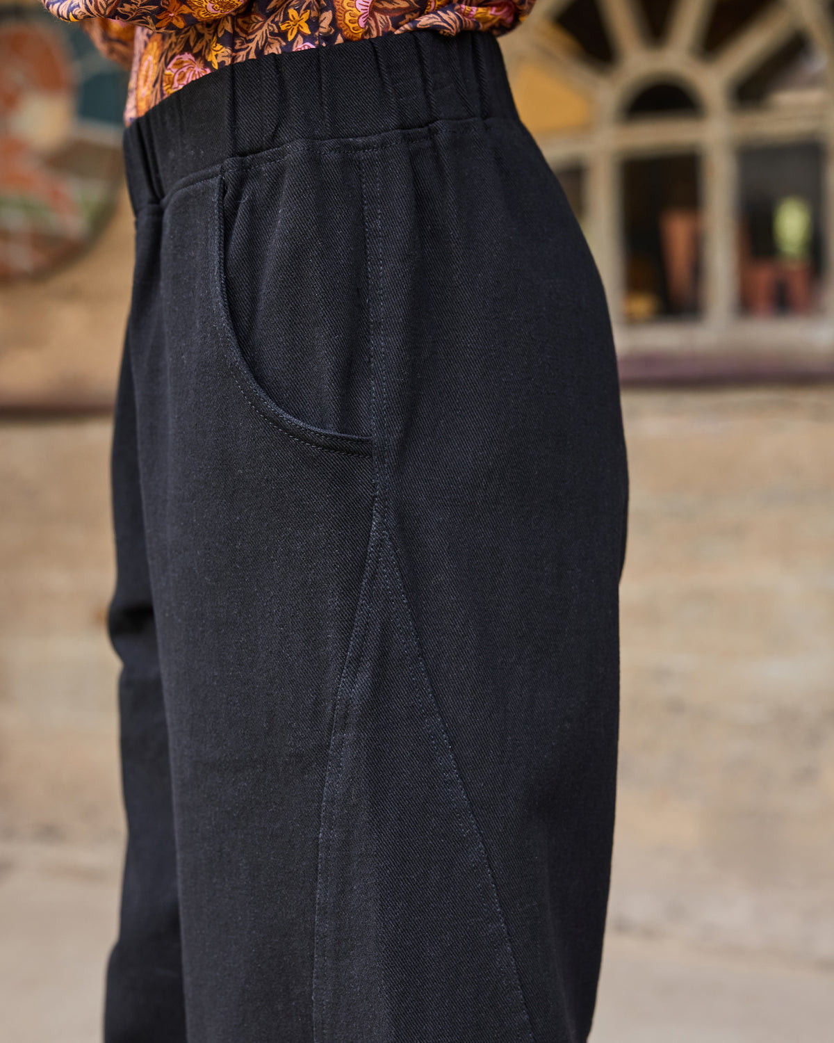 Close-up of the Wilder Pant showing the elastic waistband, side pocket opening, and stitching detail.