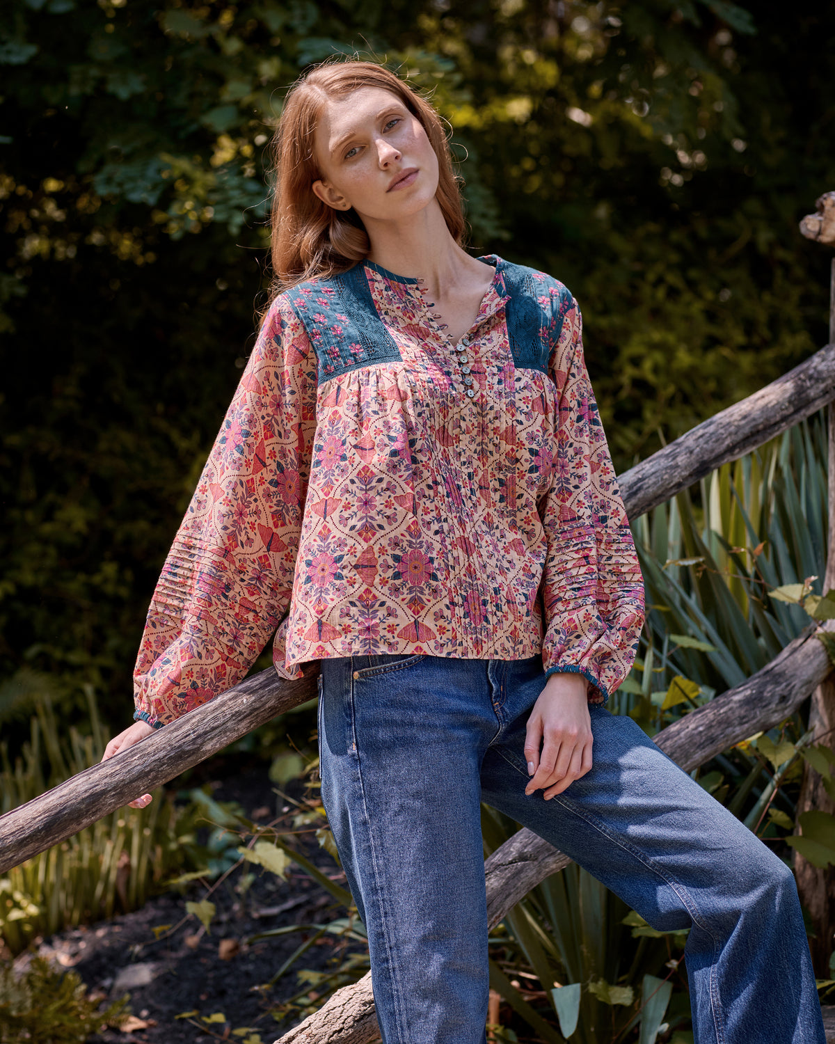 Front view of the Winged Tapestry Denver blouse showing its floral print, blue yoke panels, button placket, and gathered sleeves.