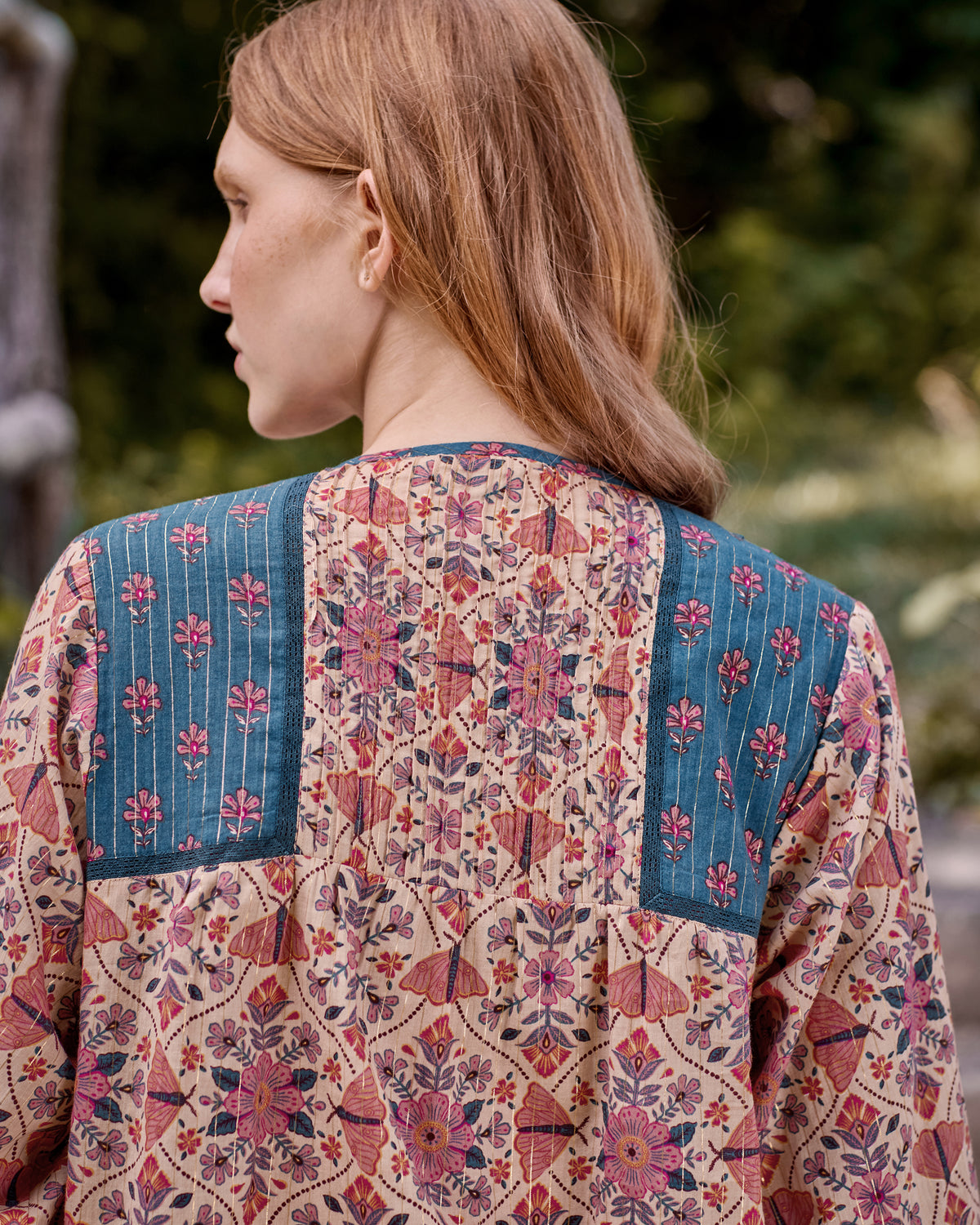 Back view of the Winged Tapestry Denver blouse showing the floral print and blue yoke panels.