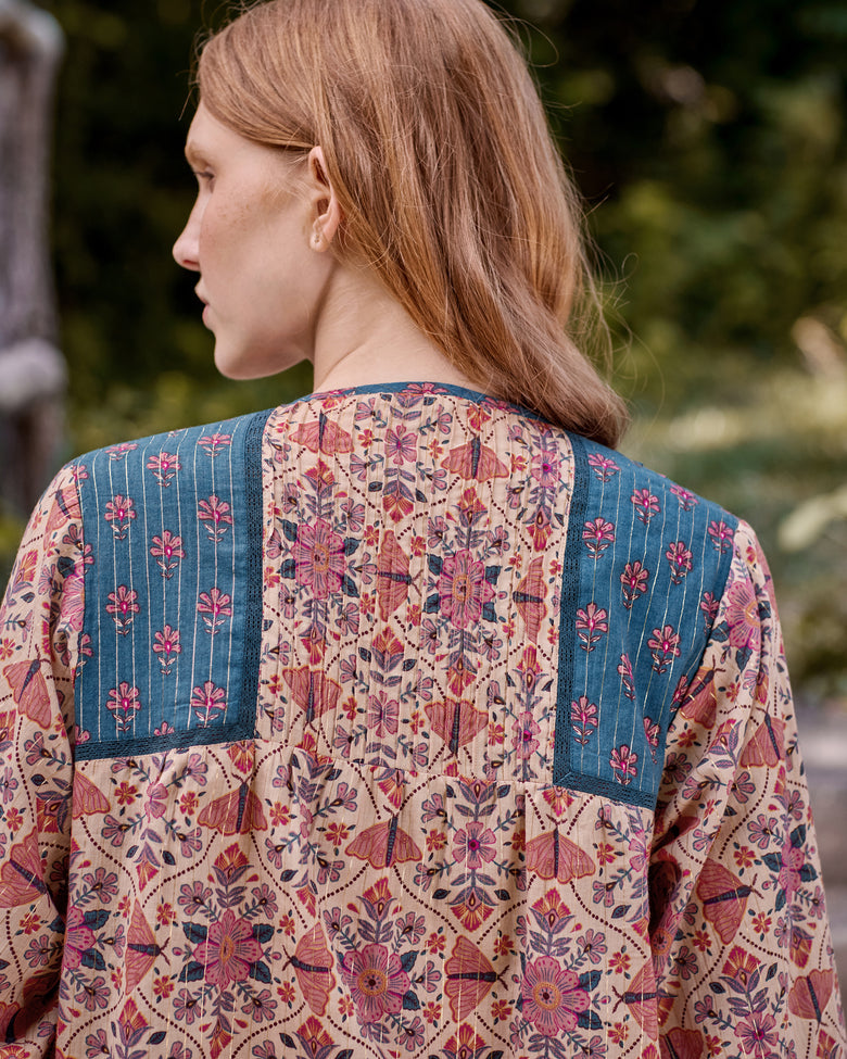 Back view of the Winged Tapestry Denver blouse showing the floral print and blue yoke panels.