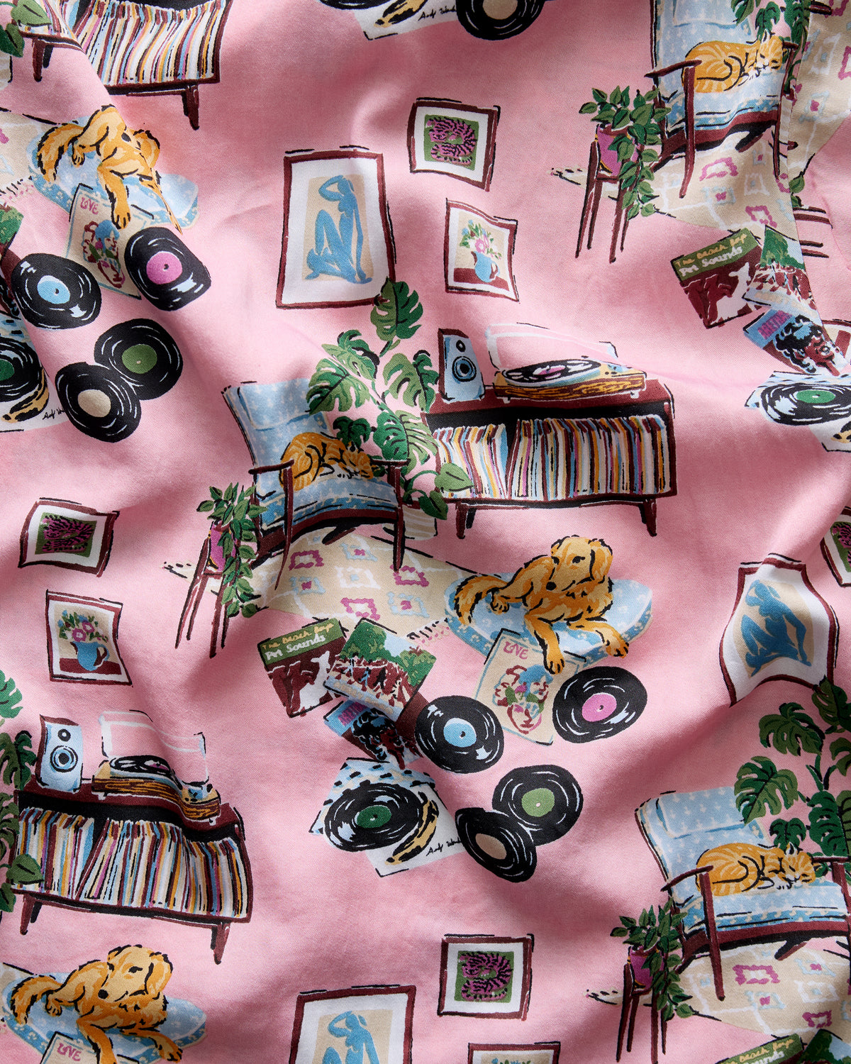 Pink pajama fabric featuring records, dogs, framed artwork, plants, and mid-century furniture.