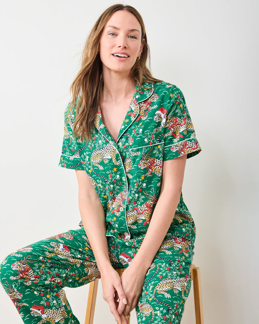 Front seated view of the mistletoe short-sleeve pajama top and full-length pants