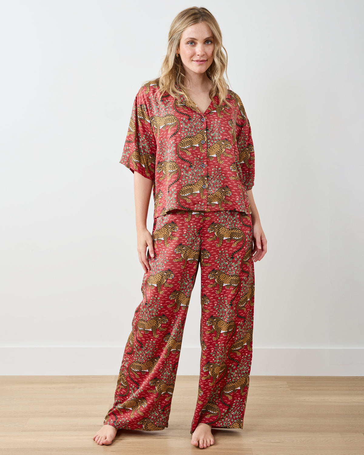 Front view of the Scarlet Bagheera pajama set with a cropped short-sleeve button top and wide-leg pants in a leopard print.