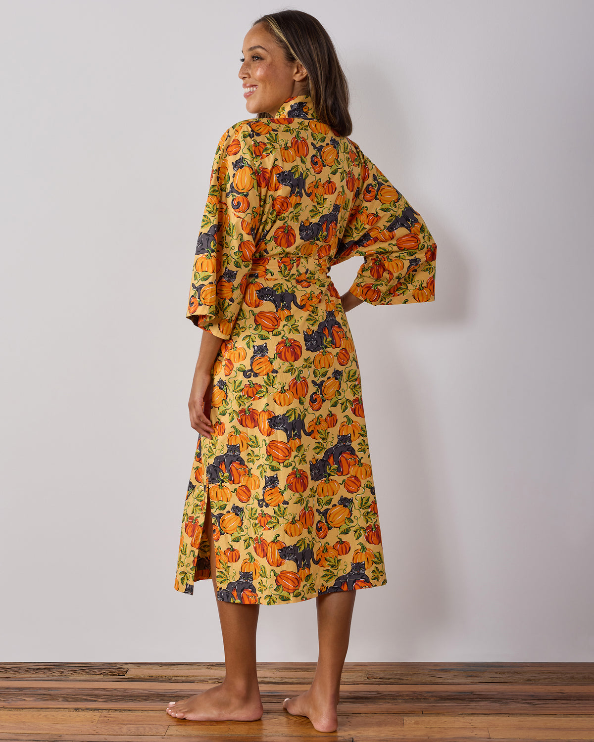 Back view of the Pumpkin Prowl salted caramel long robe, showing its pumpkin-and-black-cat print, long length, sleeves, belt, and pockets.