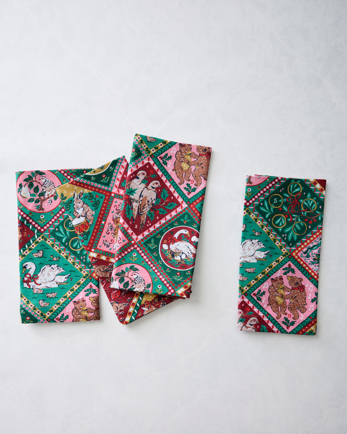 Four printed dinner napkins displayed separately to show the holiday pattern.