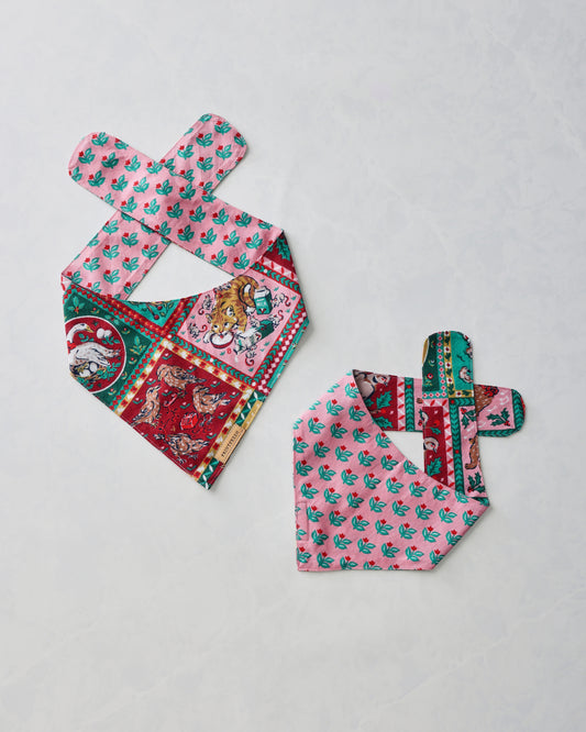 Two pet bandanas shown flat, featuring a colorful vintage holiday print and pink floral reverse panels.