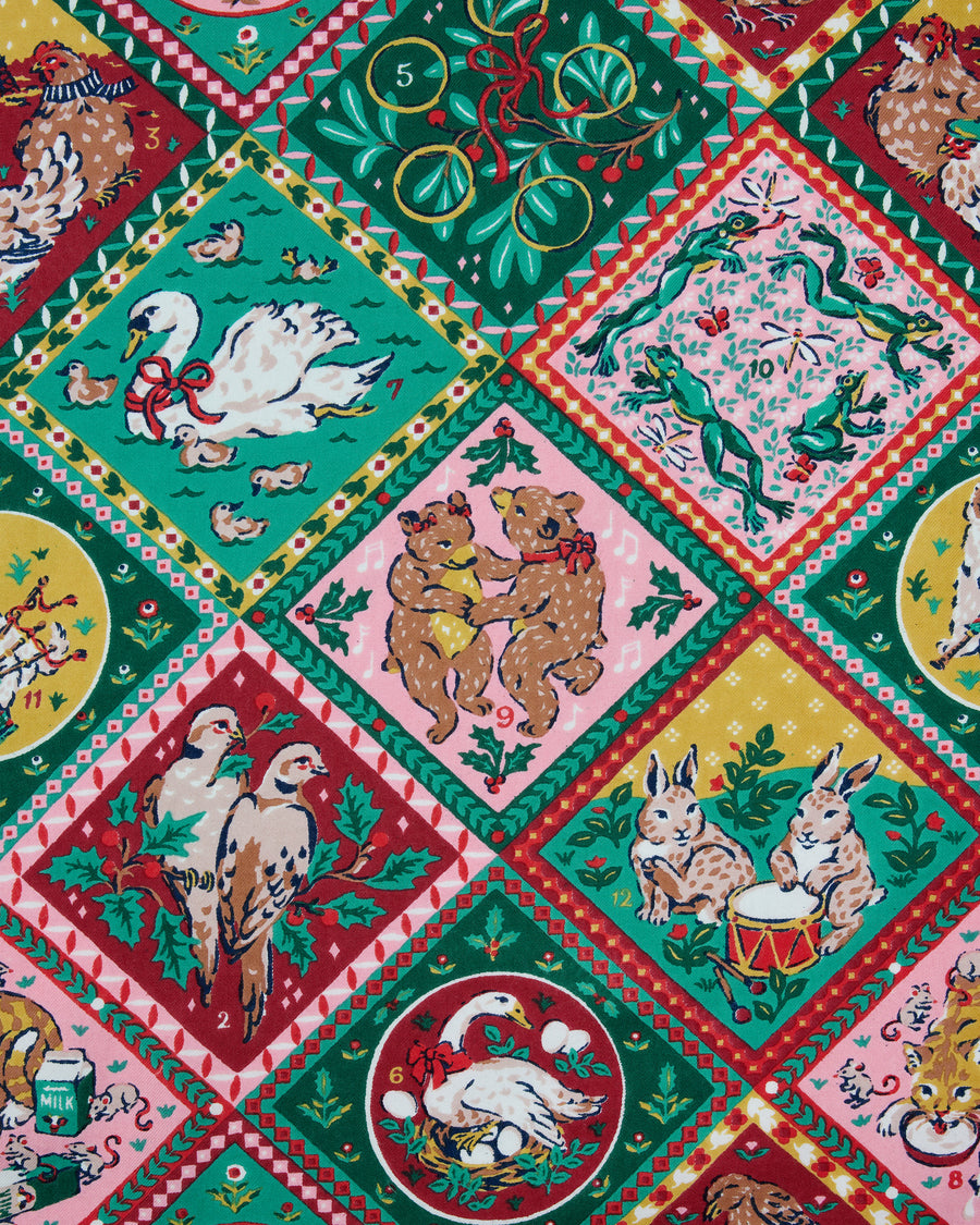 Close-up of the Vintage Holiday 12 Days of Christmas print with illustrated panels of holiday animals, greenery, and decorative borders.