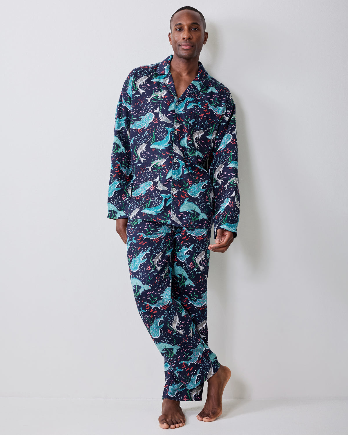 Front view of a person wearing the Arctic Sealife long pajama set with a dark navy sealife print.