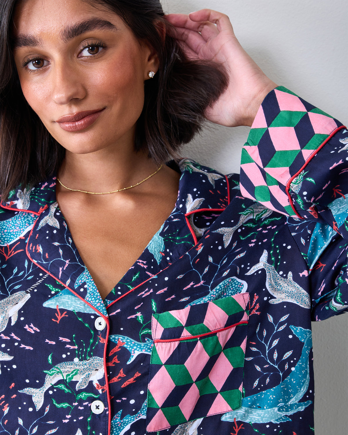 Close view of the Blue Chill Arctic Sealife pajama top with a chest pocket, white buttons, red piping, and geometric cuffs