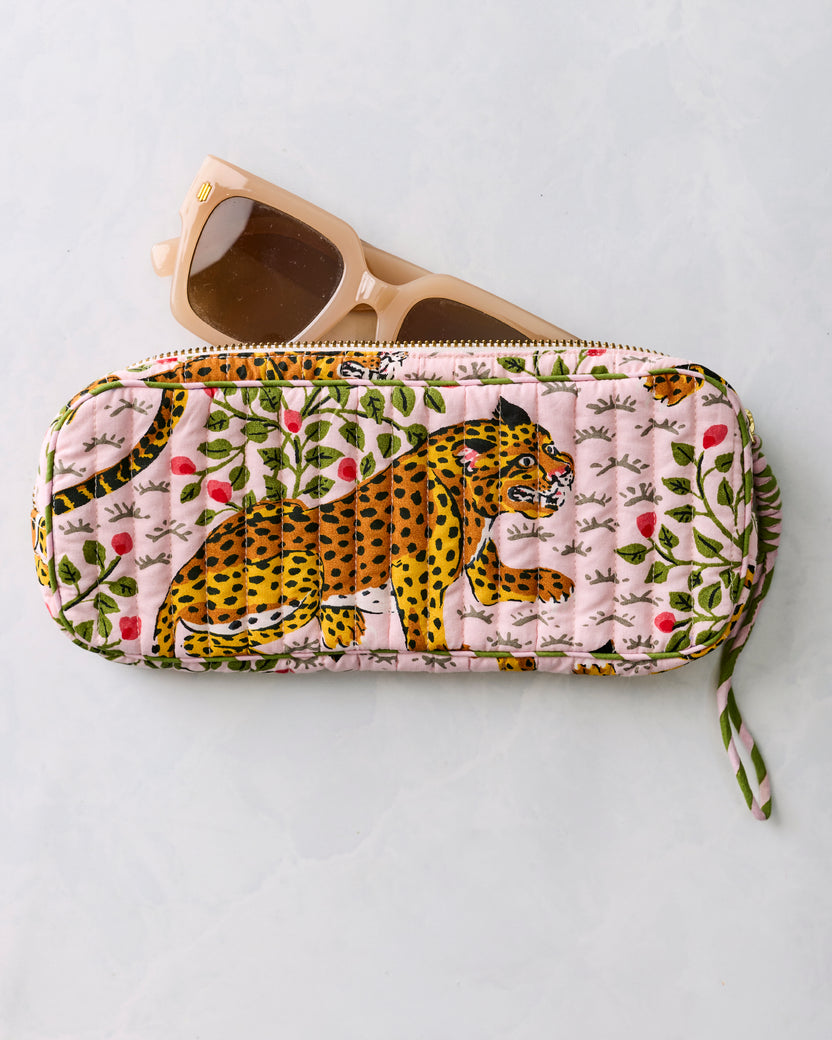 Pink quilted leopard-print sunglasses case with beige sunglasses resting partly inside
