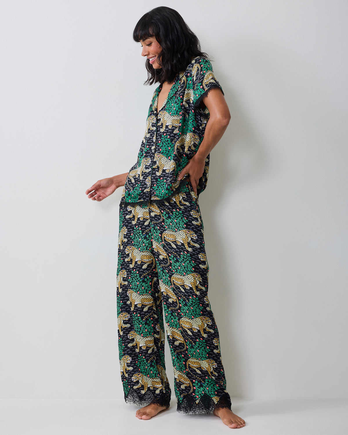 Side view of the Bagheera Ink Jackie pajama set showing the button-down top, matching pants, and lace-trimmed hems.
