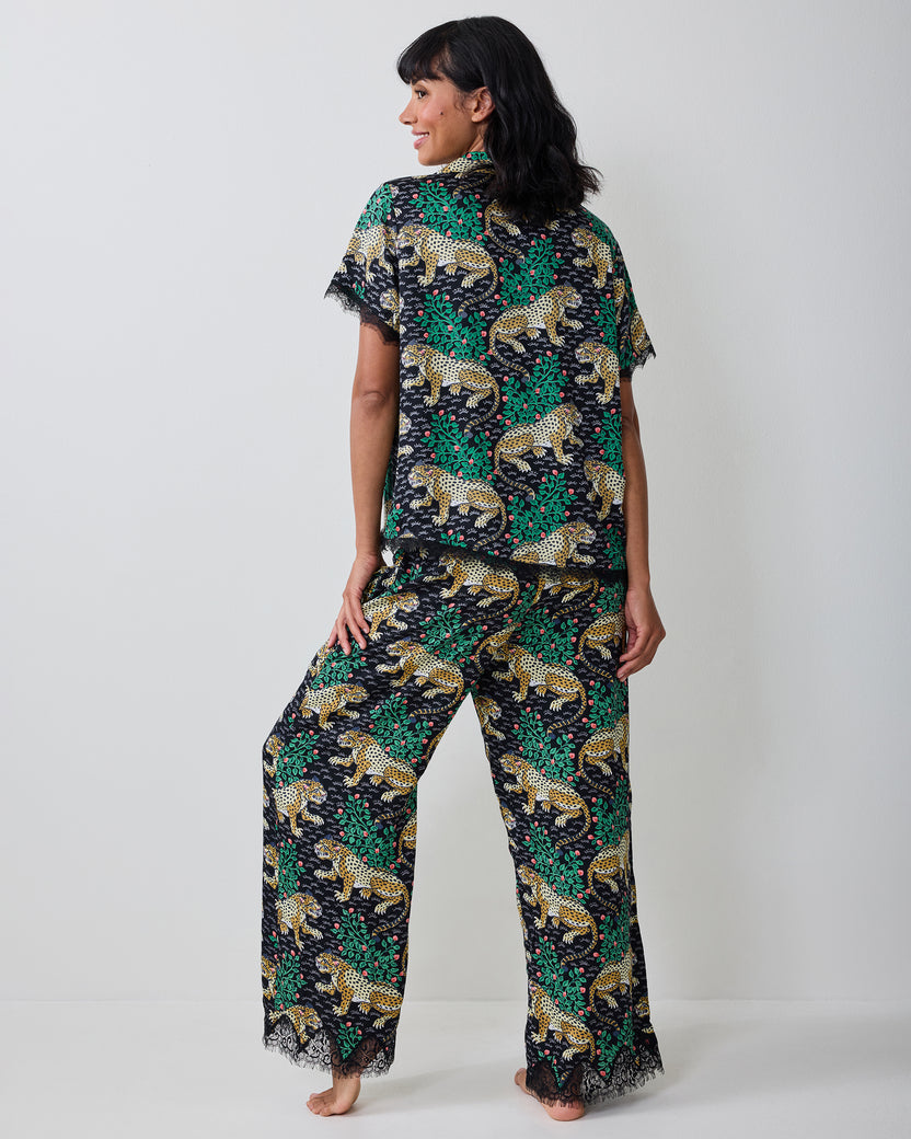 Back view of the Bagheera Ink pajama top and pants, showing the leopard-and-leaf print and lace-trimmed hems.