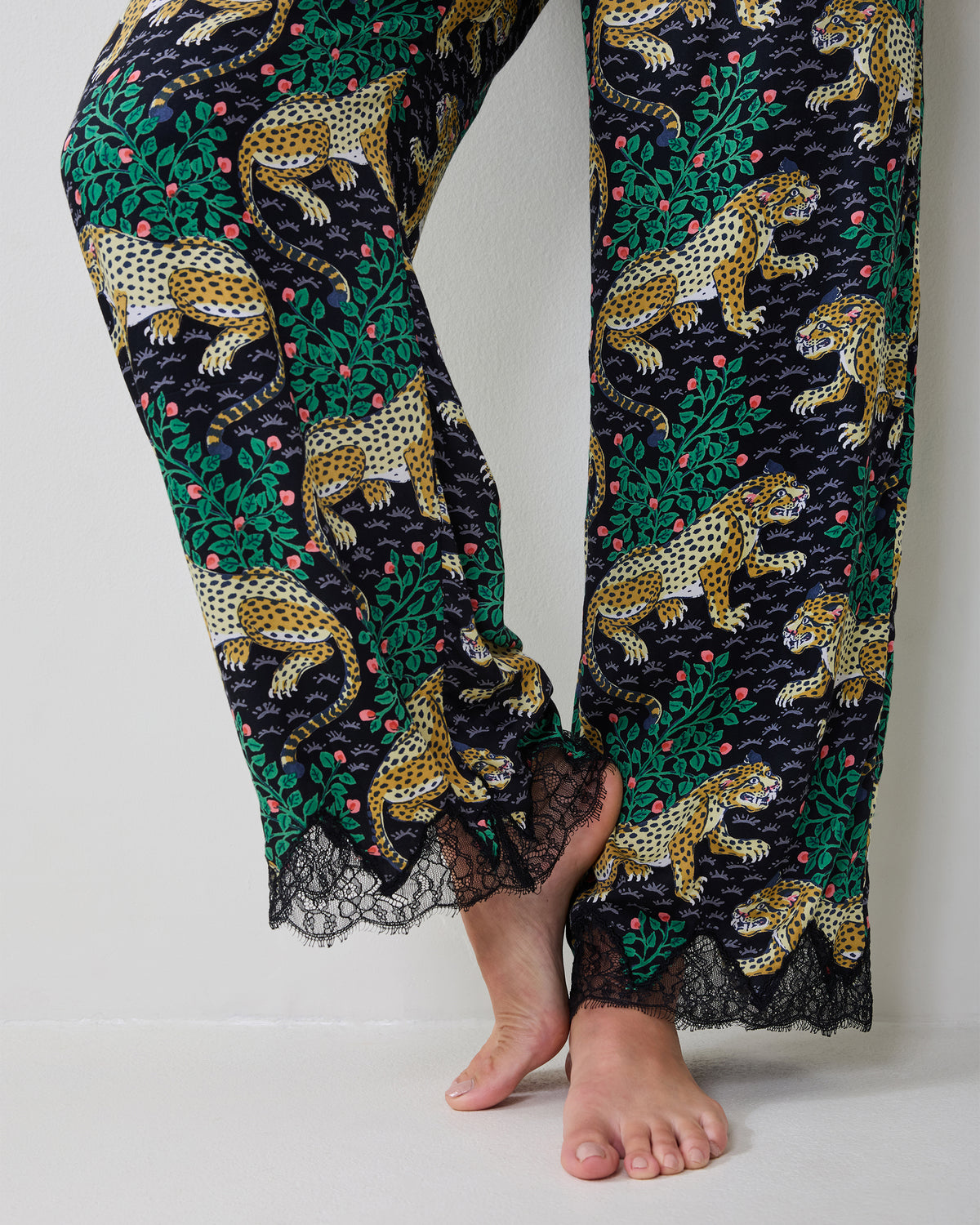 Close view of the Bagheera Eco Satin Georgia Set pant legs, showing black lace trim at the hems.