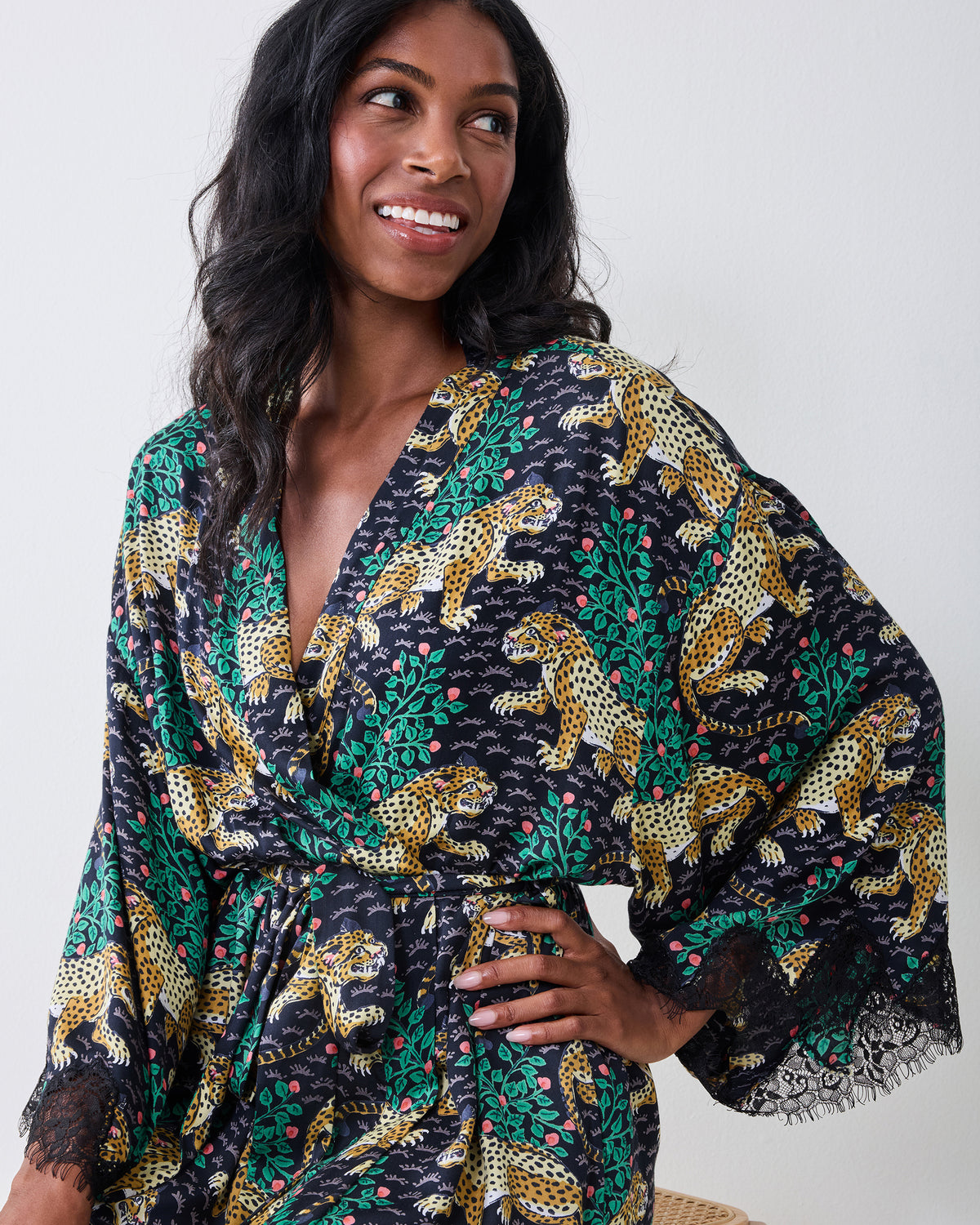 Model wearing the Bagheera Ink lace robe with a matching belt and lace-trimmed bell sleeves.