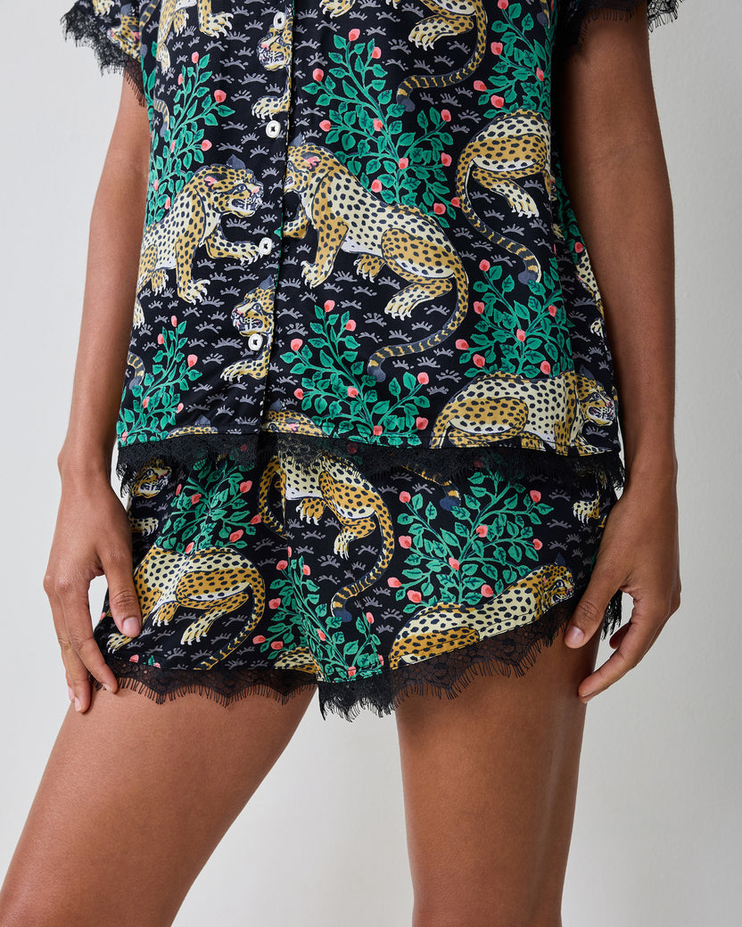 Close-up of the Bagheera Eco Satin Maryanne Set in Ink, showing the button-front top hem and matching shorts with lace trim.