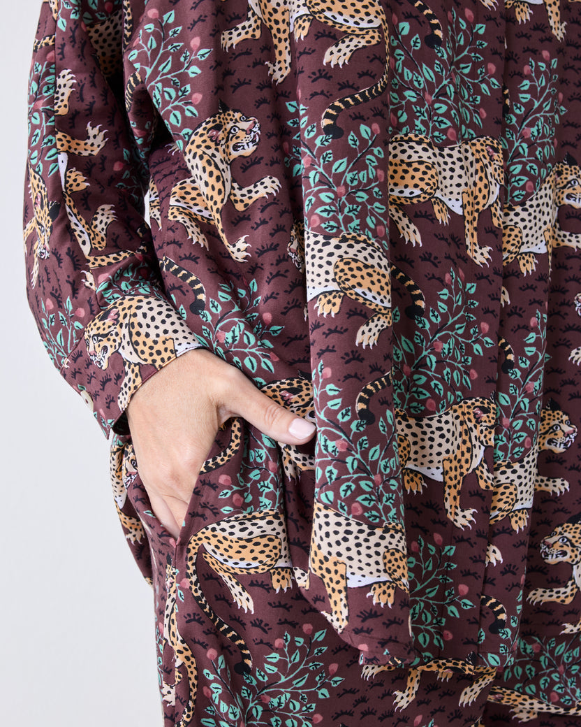 Close-up of the raisin pajama set showing a leopard-and-leaf print, long sleeve, and side pocket.