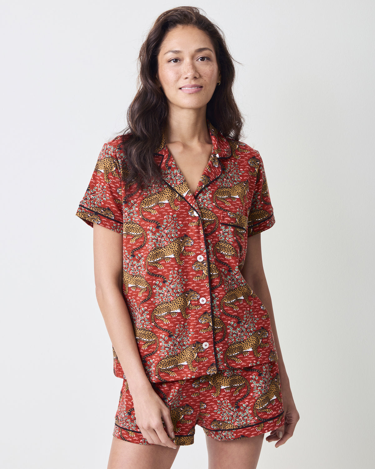 Front view of the scarlet Bagheera short pajama set with a collared button-front top and matching shorts in a leopard-and-leaf print.