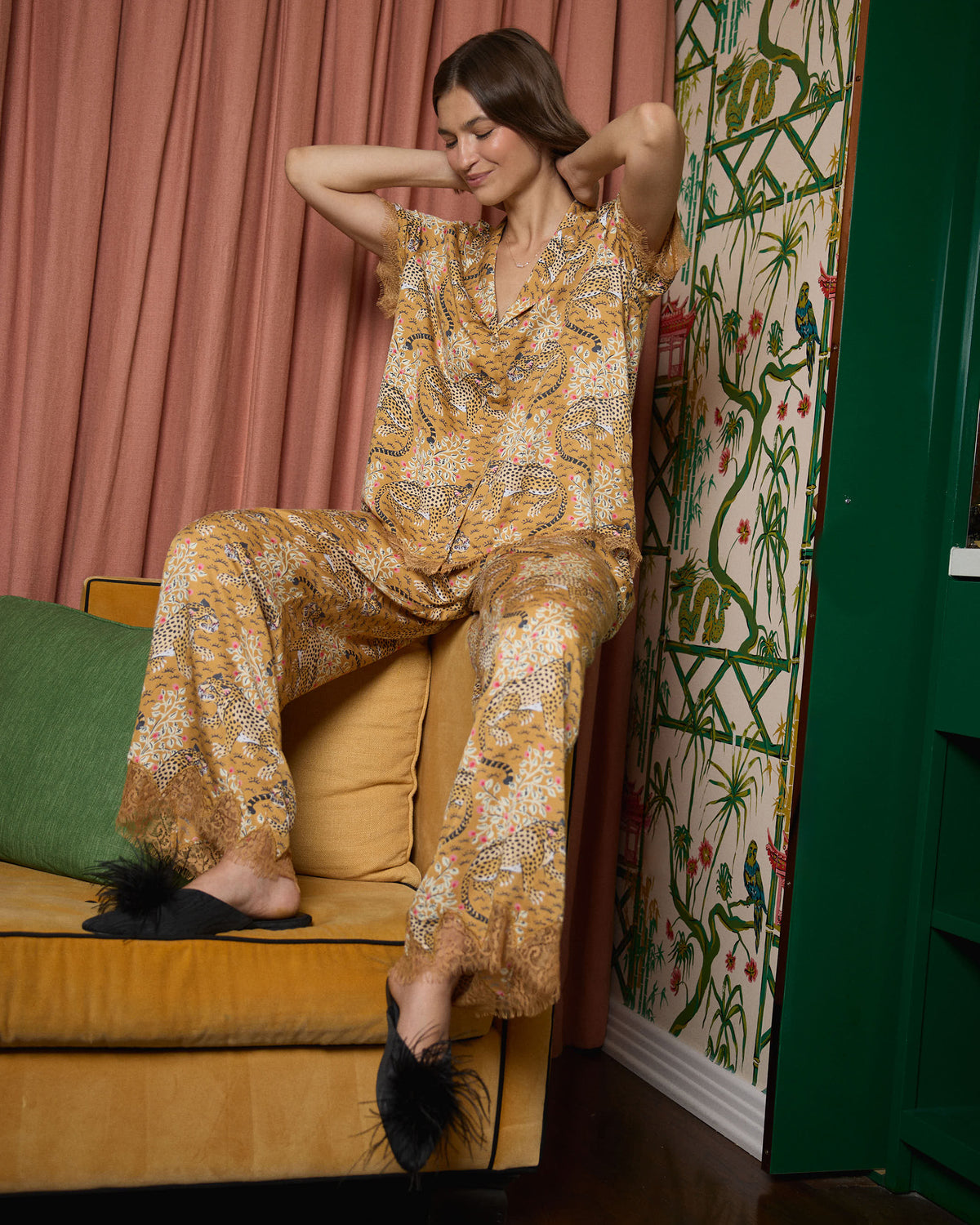 Person wearing the tobacco Bagheera Eco Satin Jackie set, seated in a chair with the patterned top and matching pants visible.