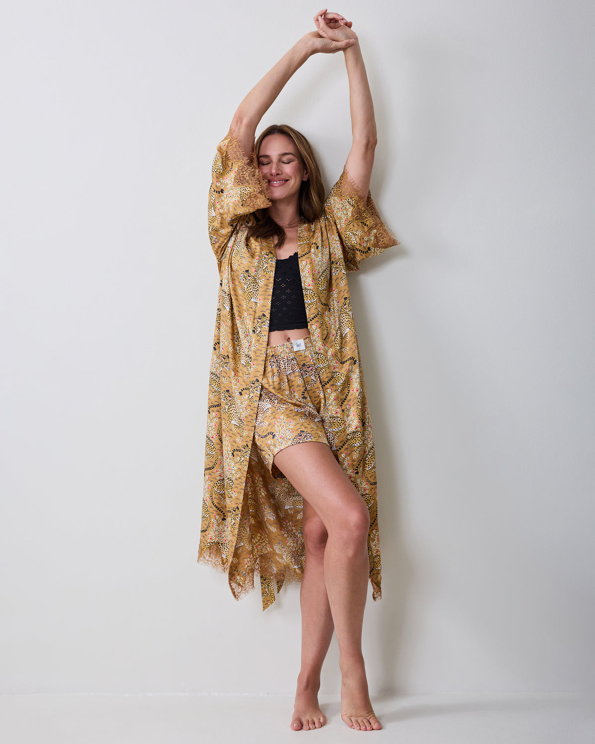 Bagheera tobacco lace robe shown full length, worn open over a black top and printed shorts.
