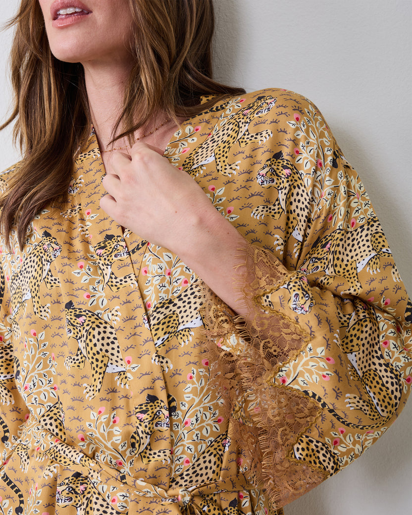 Close view of the Bagheera Tobacco leopard-print robe showing the lace-trimmed sleeve cuff and botanical print.