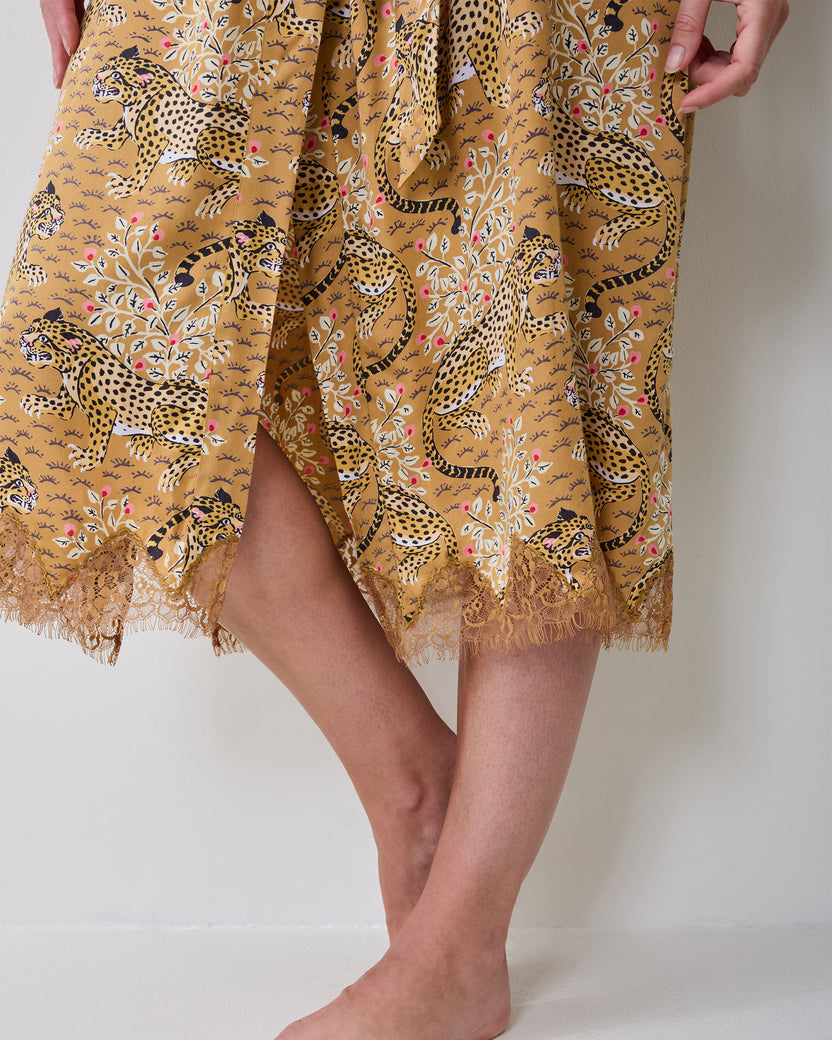 Close-up of the Bagheera tobacco lace robe hem showing the leopard-and-floral print and lace trim.