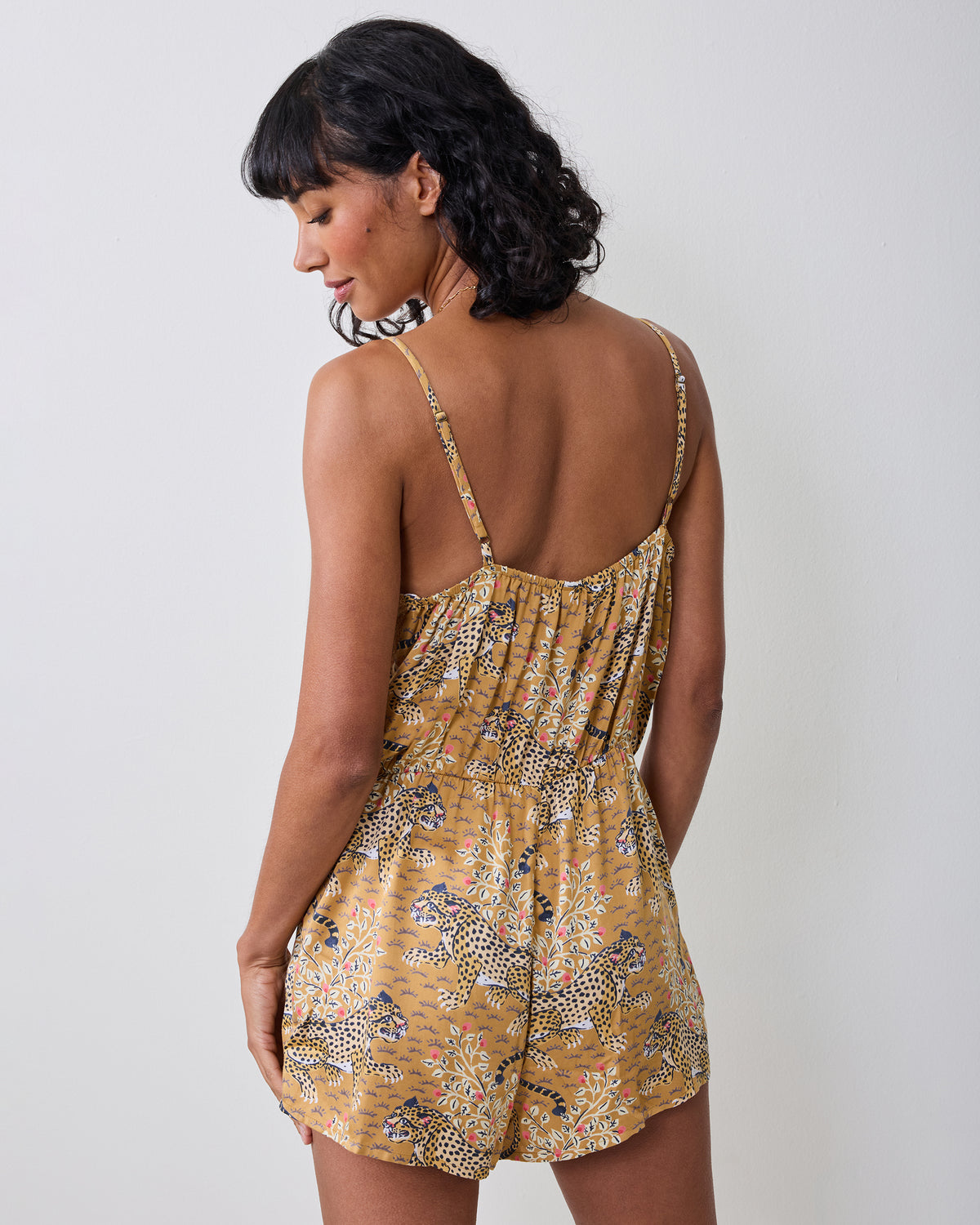 Back view of the tobacco Bagheera Madeline romper with thin straps, an elasticated back, and a leopard-and-floral print.