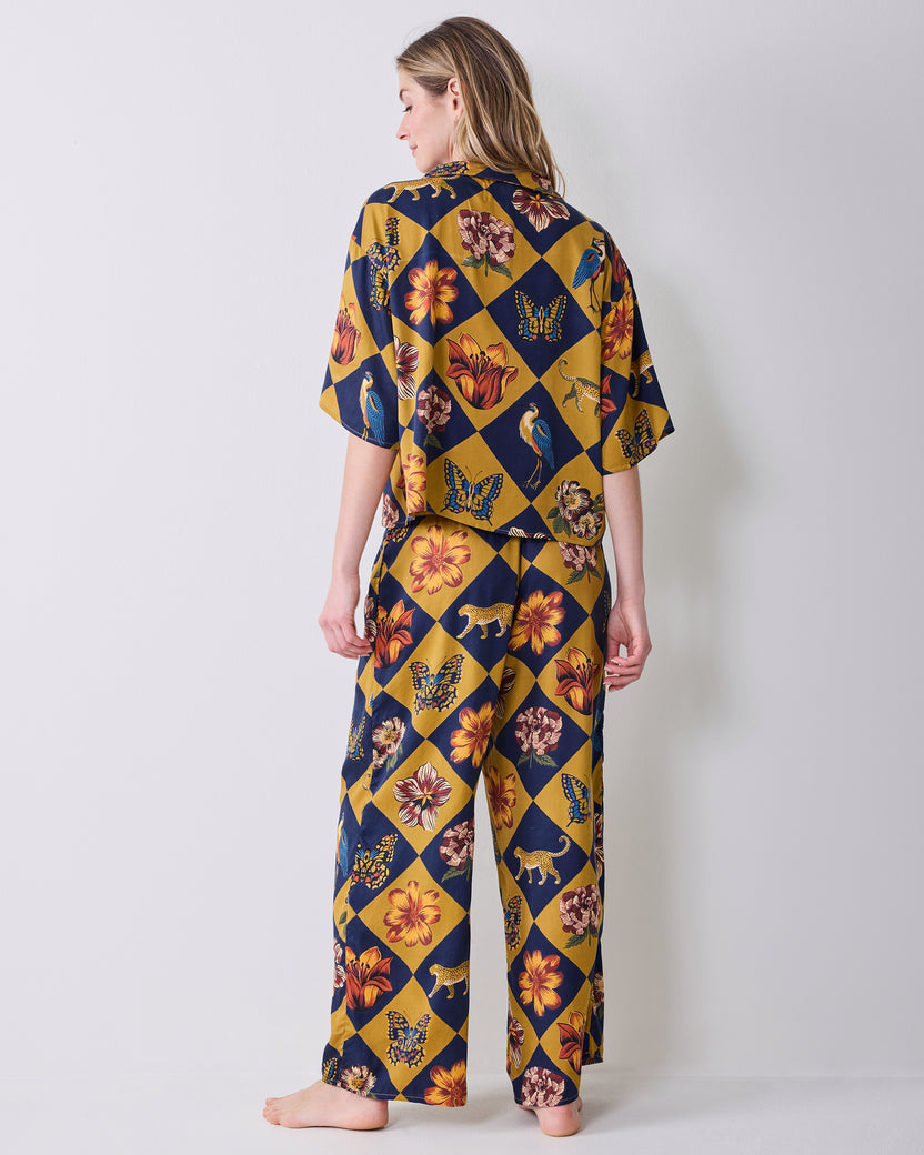 Back view of a person wearing the Golden Hour Botanical Checkerboard short-sleeved top and matching wide-leg pants.