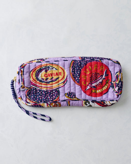 Lavender quilted zippered sunglasses case with a patterned print and wrist strap, shown closed.