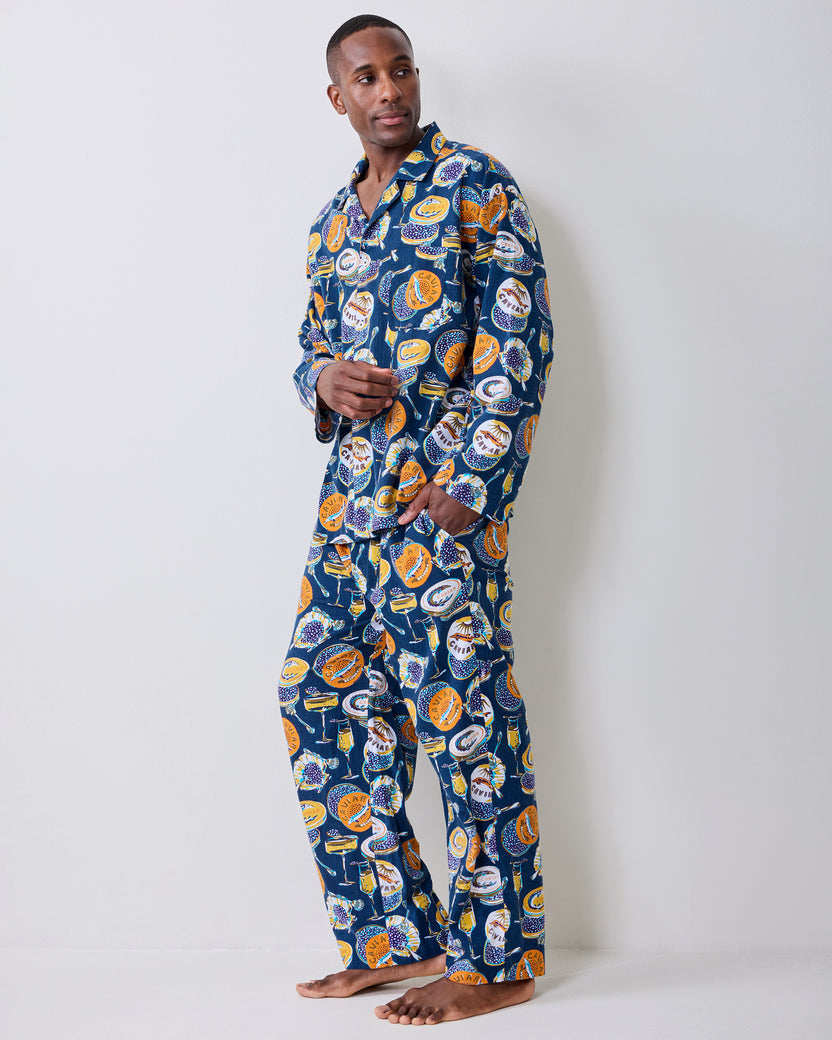 Three-quarter side view of a model wearing the navy Champagne & Caviar long pajama set.