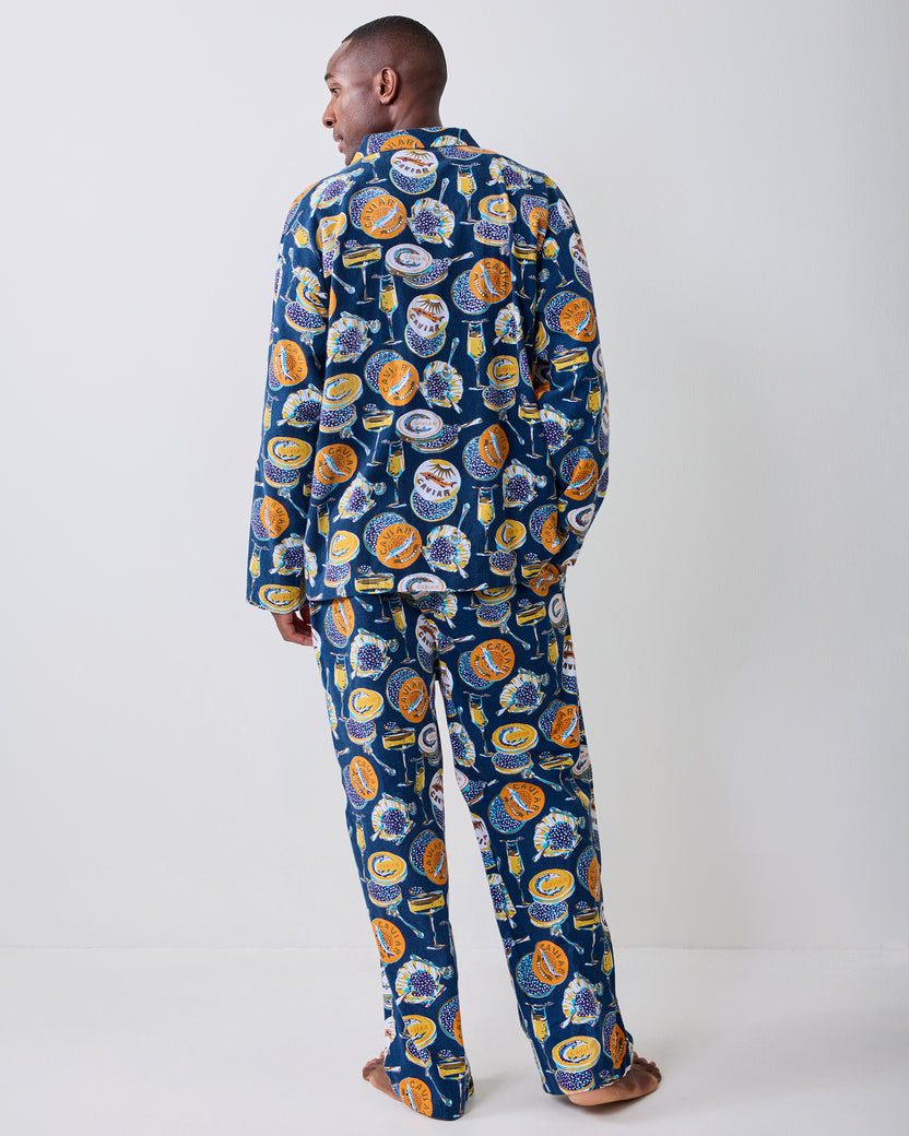 Back view of a model wearing the navy Champagne & Caviar long pajama set.