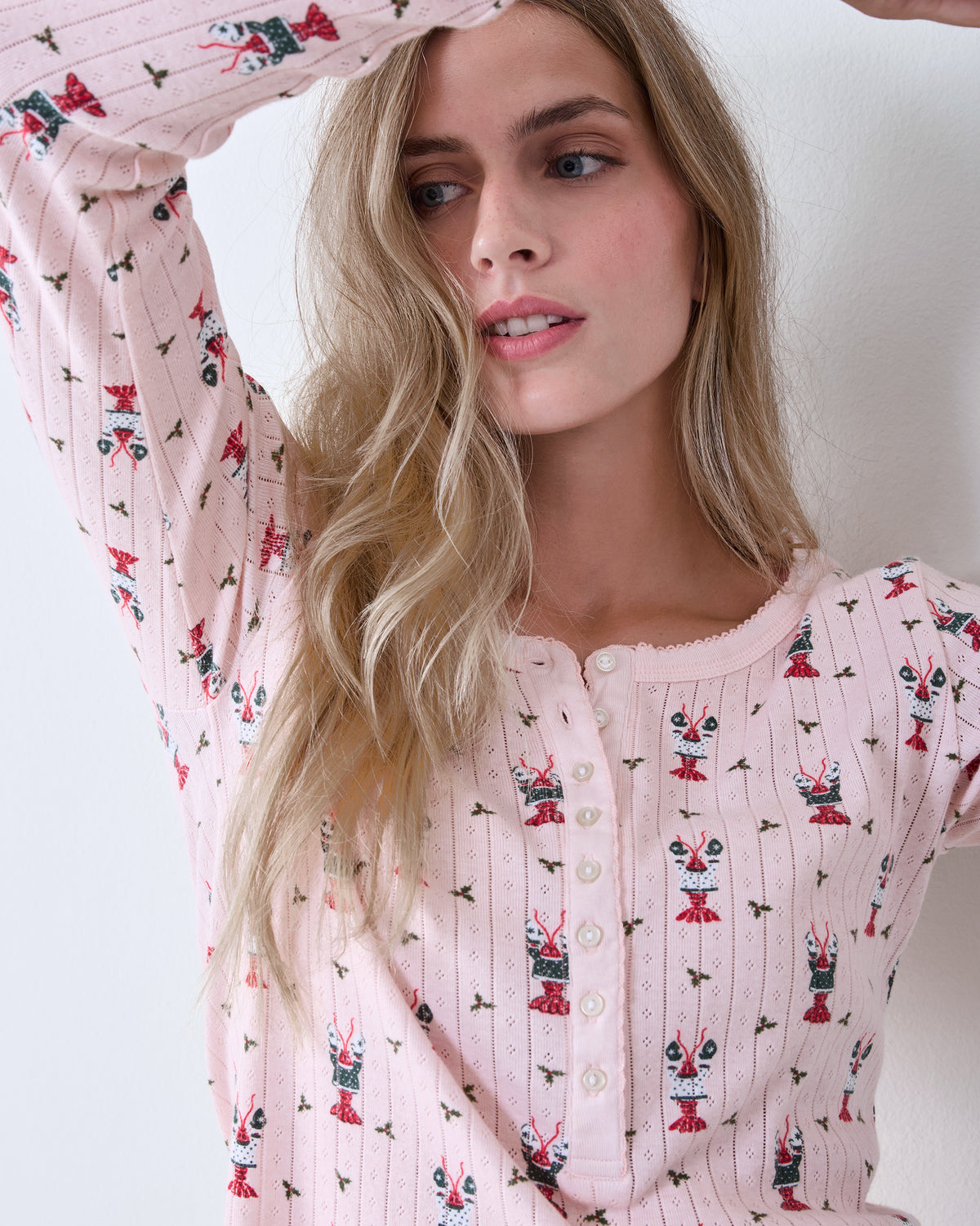 Close-up front view of the Christmas Claws Kaylee pajama top with button placket and repeated red and green claw motifs.