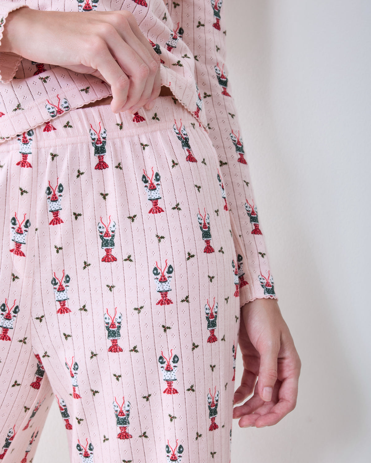 Close-up of the Christmas Claws Kaylee pajama set showing the printed top, elastic waistband, and claw motif.