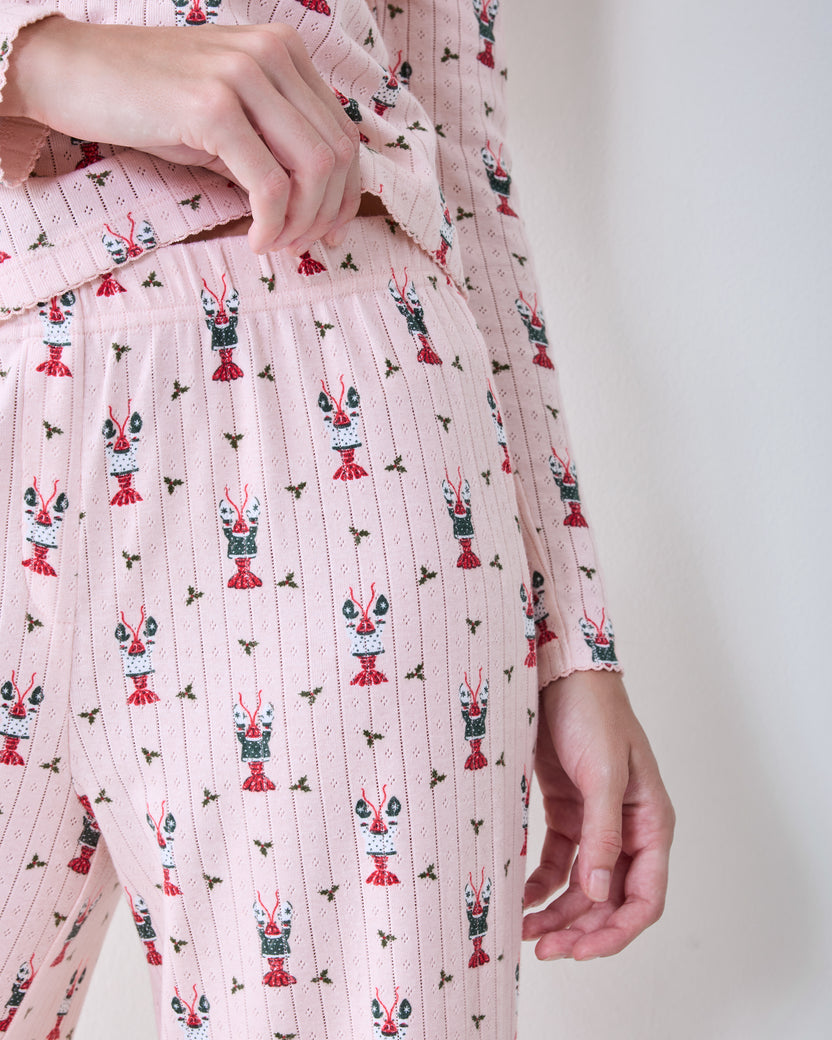 Close-up of the Christmas Claws Kaylee pajama set showing the printed top, elastic waistband, and claw motif.
